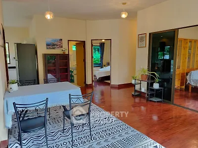 Spacious open-plan living and dining area with hardwood floors and modern decor
