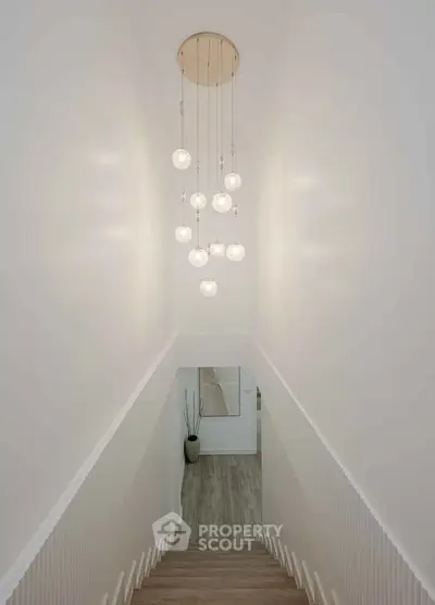 Elegant staircase with modern chandelier in a stylish home interior