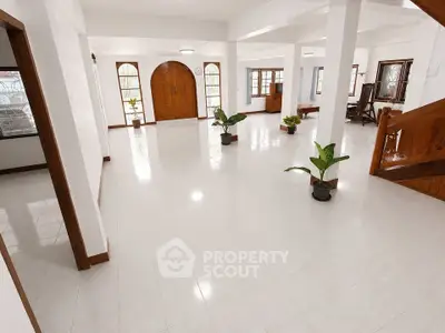 Spacious open-plan living area with elegant wooden accents and abundant natural light.