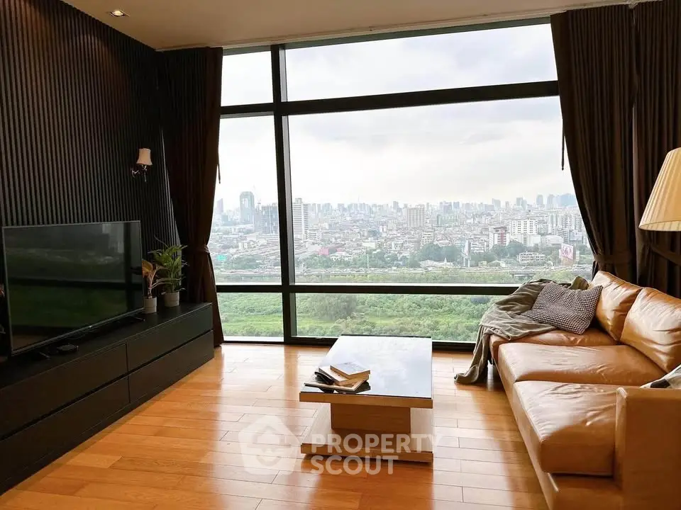 Luxurious living room with panoramic city view and elegant furnishings.