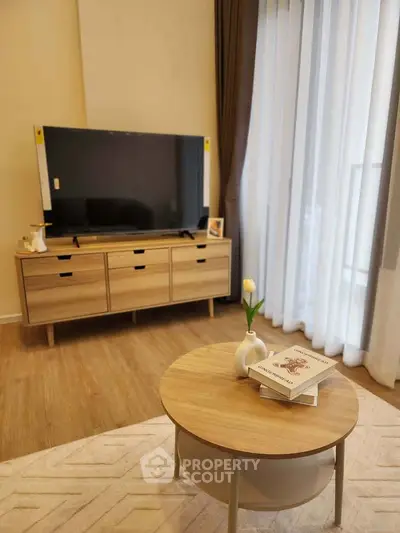 Modern living room with stylish wooden furniture and large TV, perfect for relaxation and entertainment.