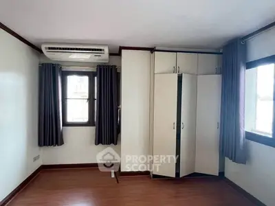 Spacious bedroom with air conditioning and ample natural light