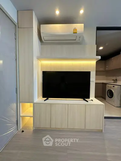Modern living room with built-in TV unit and air conditioning, featuring sleek design and ambient lighting.