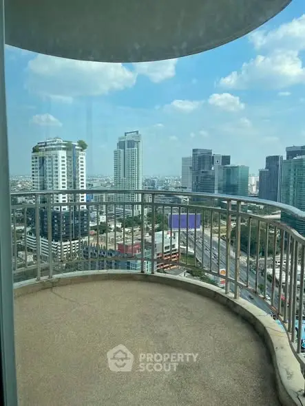 Stunning cityscape view from a high-rise balcony with modern skyline.
