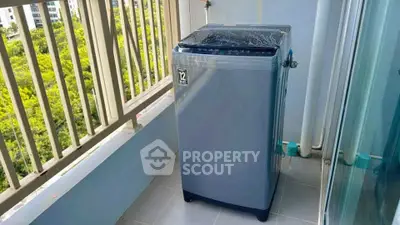 Modern washing machine on a balcony with a scenic view, perfect for urban living convenience.