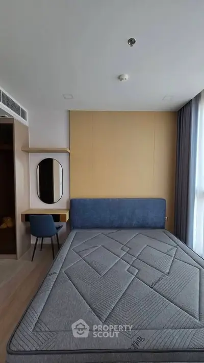 Modern bedroom with stylish bed and elegant decor in a contemporary apartment.