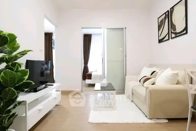 Modern living room with cozy sofa, TV, and stylish decor in bright apartment.