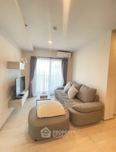 Modern living room with cozy sofa and natural light in stylish apartment