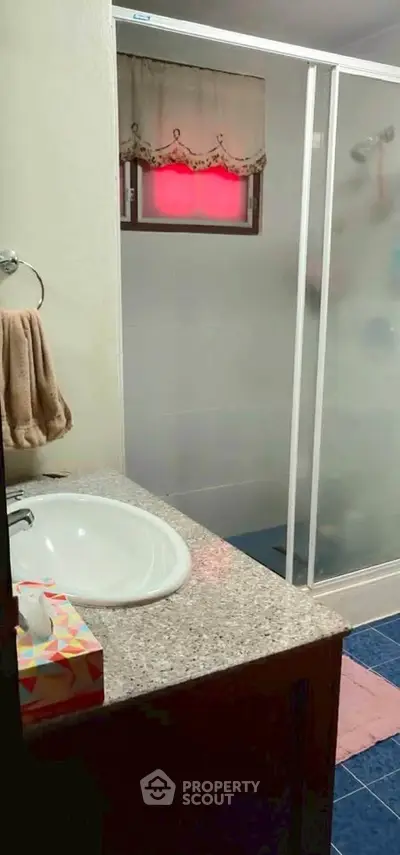 Cozy bathroom with granite countertop and shower enclosure