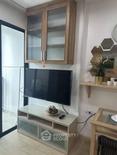 Modern living room with wall-mounted TV and stylish wooden cabinets