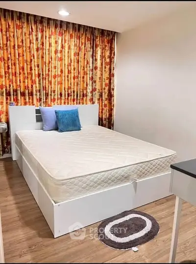 Cozy bedroom with stylish curtains and modern furnishings