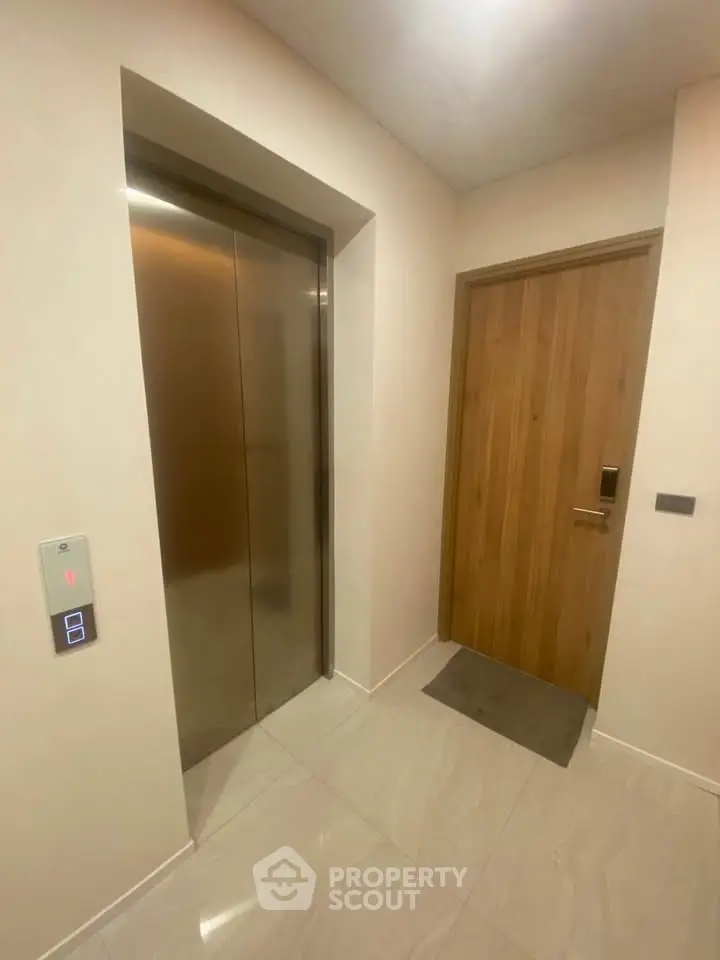 Modern apartment elevator and entrance door with sleek design and polished flooring.