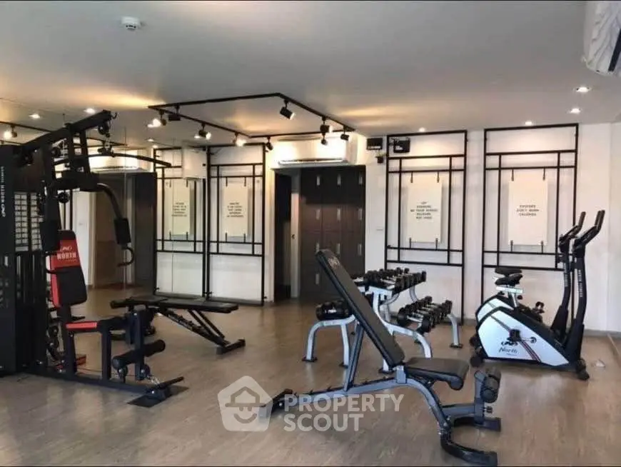Modern gym with state-of-the-art fitness equipment in a stylish residential building.