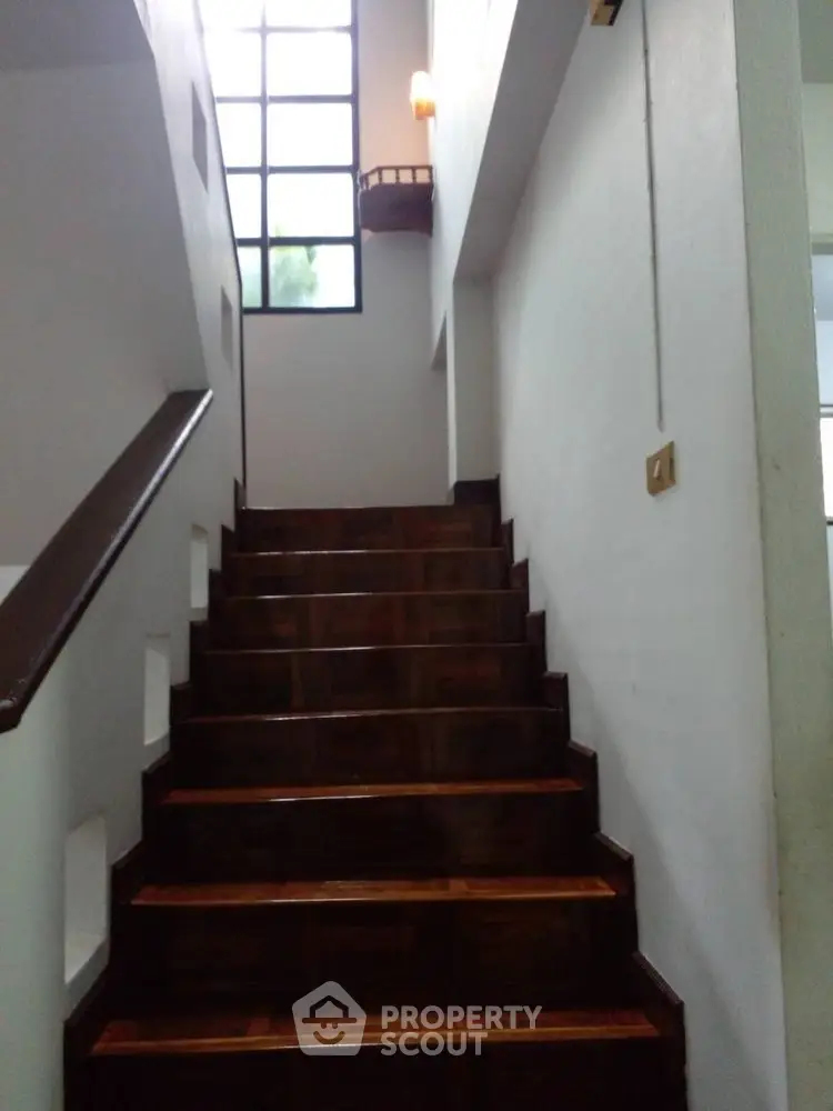 Elegant wooden staircase with natural light in modern home