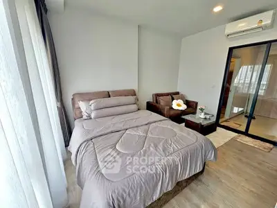 Modern bedroom with cozy bed and stylish decor in a bright apartment.