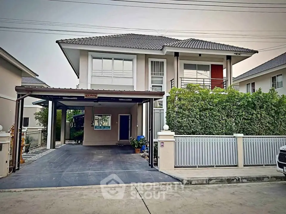 Modern two-story house with spacious driveway and lush greenery, perfect for family living.