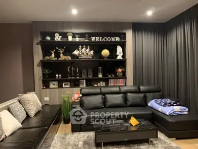 Stylish modern living room with black leather sofas and decorative shelves