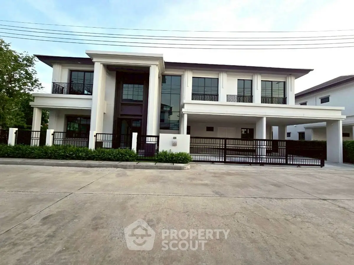 Luxurious modern two-story house with elegant facade and spacious driveway.