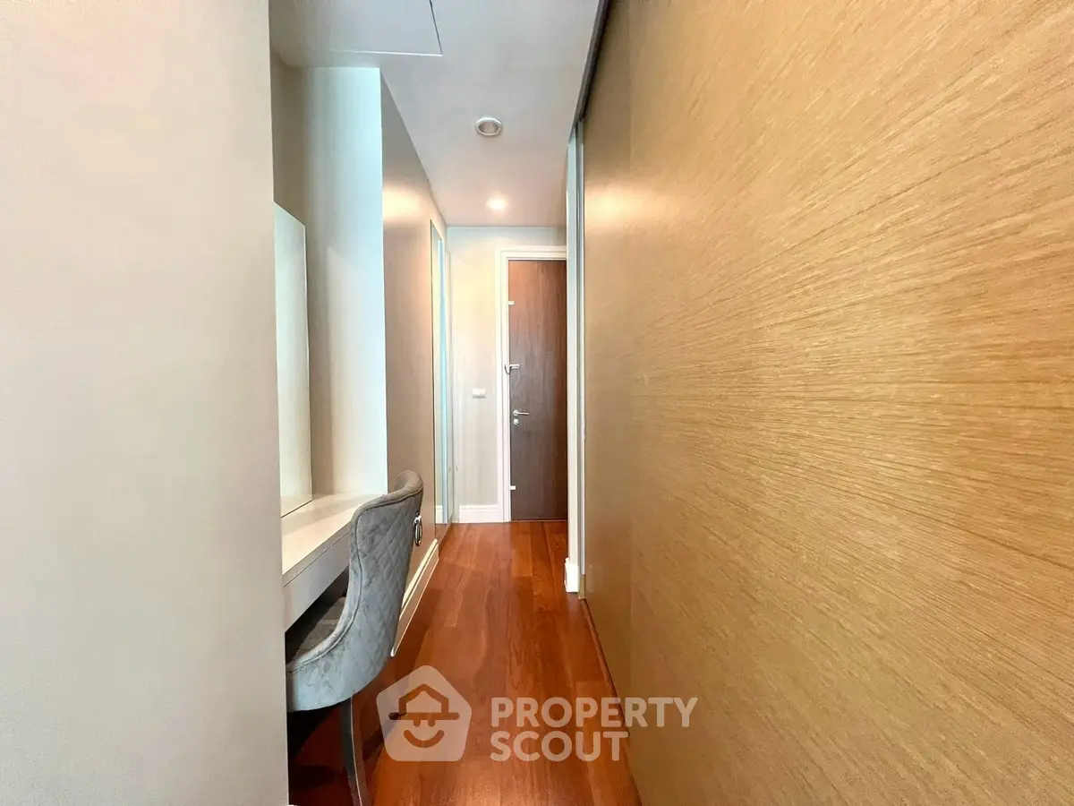 Sleek hallway with wooden accents and modern design in luxury apartment