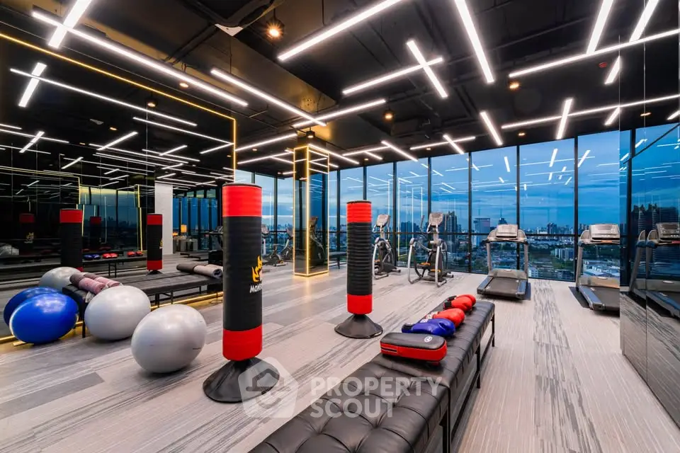 Luxurious gym with city view, modern equipment, and stylish lighting in high-end real estate property.