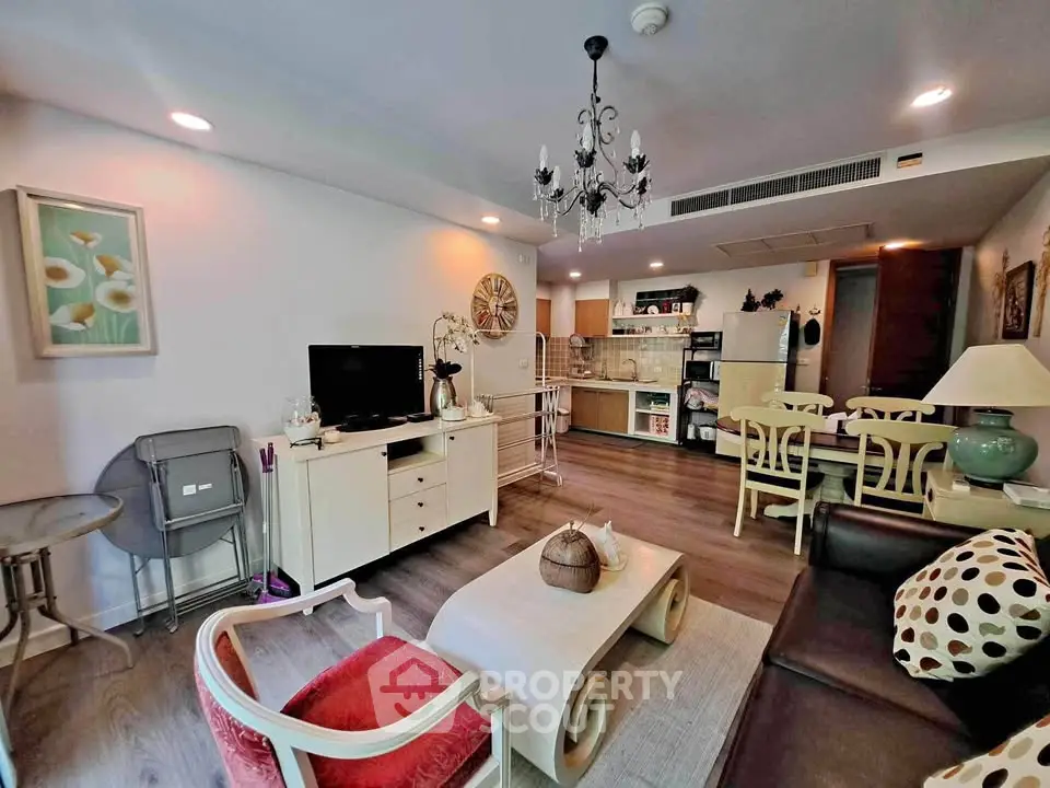 Spacious living room with elegant decor and open kitchen layout in modern apartment.