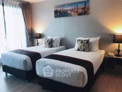 Spacious twin bedroom with elegant decor and natural light