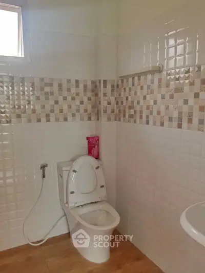 Modern bathroom with stylish tile design and wooden flooring