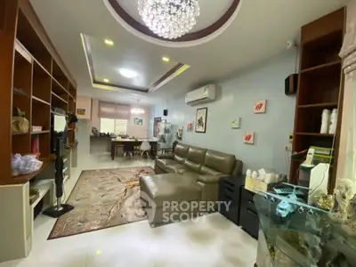 Spacious living room with modern decor and elegant chandelier