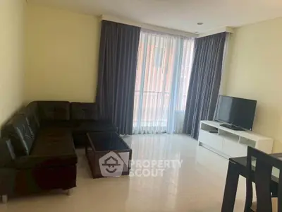 Spacious living room with modern furniture and large window for natural light.