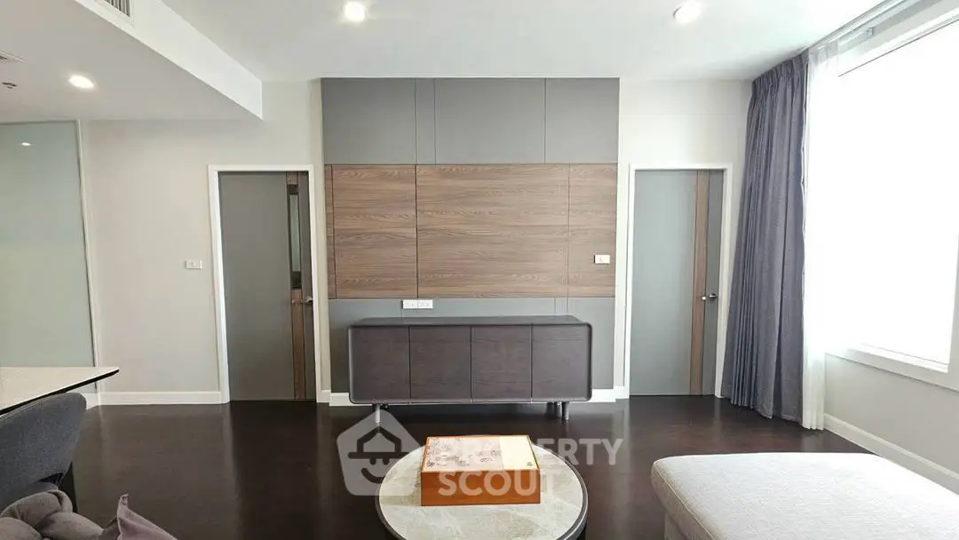 Modern living room with sleek furniture and stylish wood paneling, perfect for contemporary urban living.