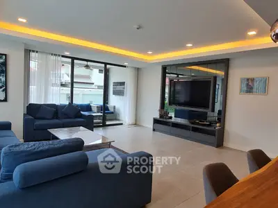 Spacious modern living room with large windows and elegant decor