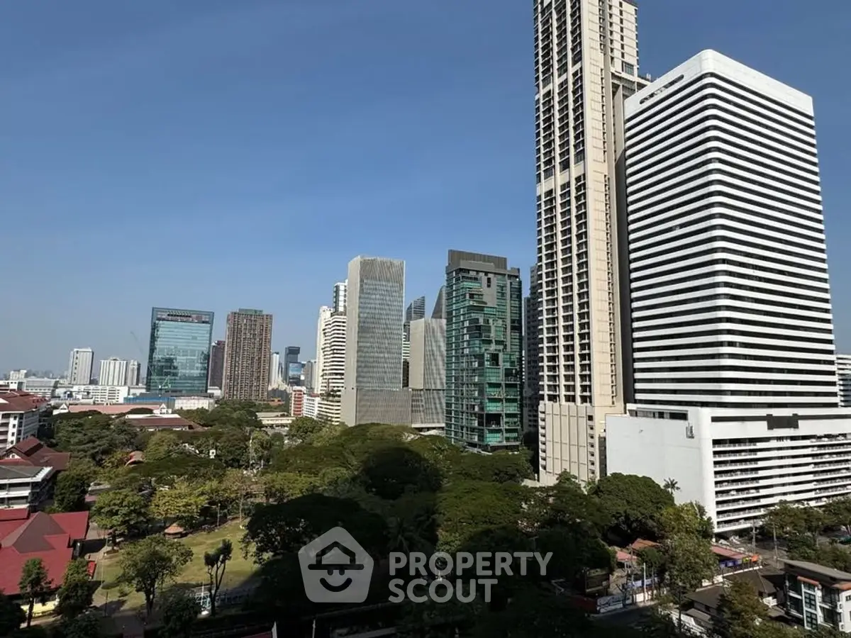 Stunning cityscape view with modern skyscrapers and lush greenery, perfect for urban living enthusiasts.