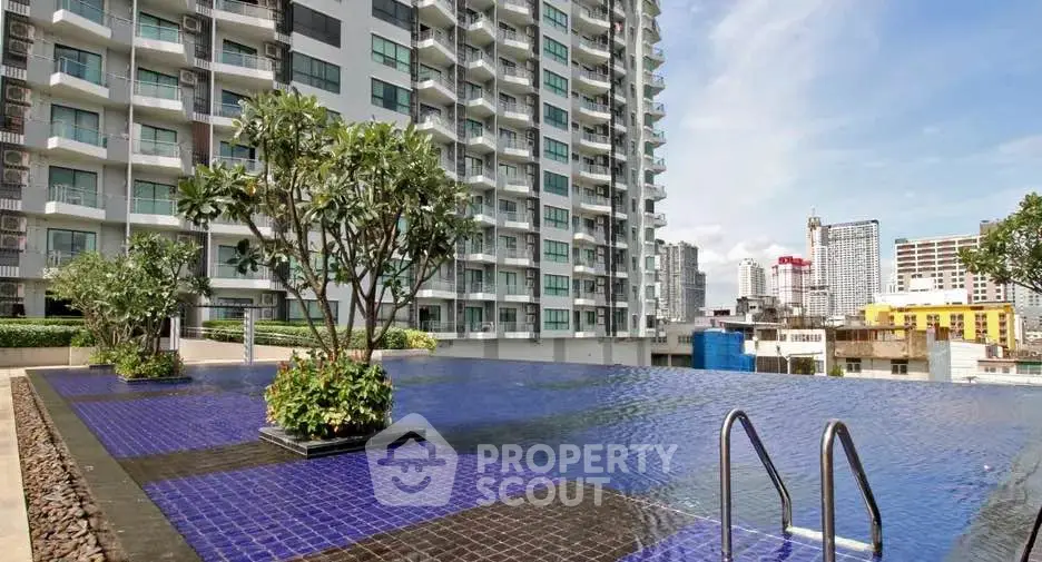 Luxurious rooftop pool with stunning city views in modern high-rise building.