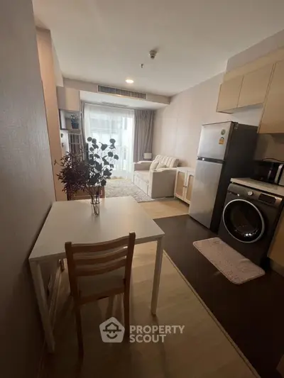 Cozy studio apartment with modern kitchen appliances and stylish living area.