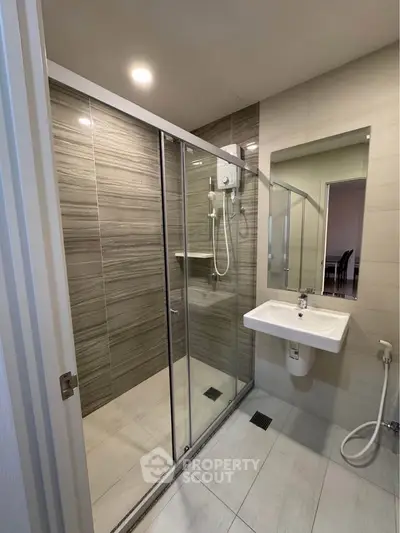 Modern bathroom with glass shower enclosure and sleek sink design