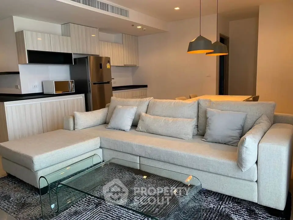 Modern living room with stylish sofa and open kitchen layout in a contemporary apartment.