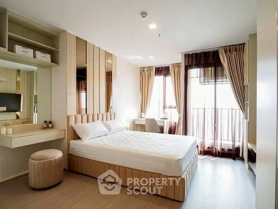 Modern bedroom with elegant decor and natural light, featuring a stylish bed and cozy workspace.