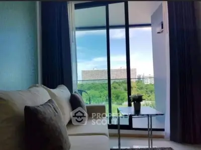 Modern living room with large windows offering a stunning city view.