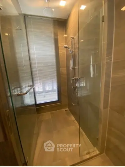 Modern bathroom with glass shower enclosure and sleek tile design
