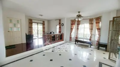 Spacious living room with elegant tile flooring and large windows