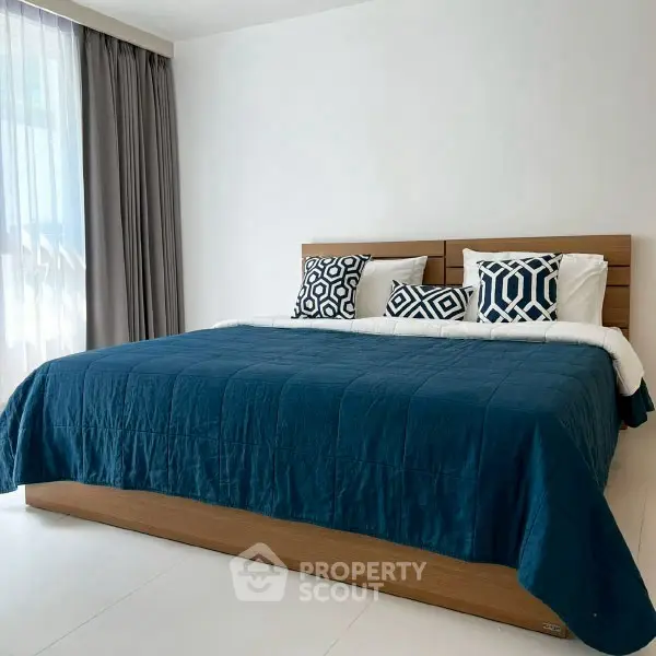 Spacious bedroom with modern decor and large bed in a bright apartment.