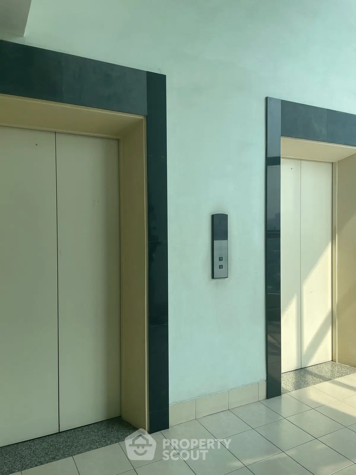 Modern building elevator area with sleek design and natural lighting