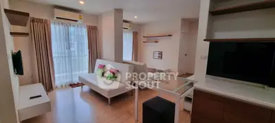 Modern living room with sleek furniture and large windows in a stylish apartment.