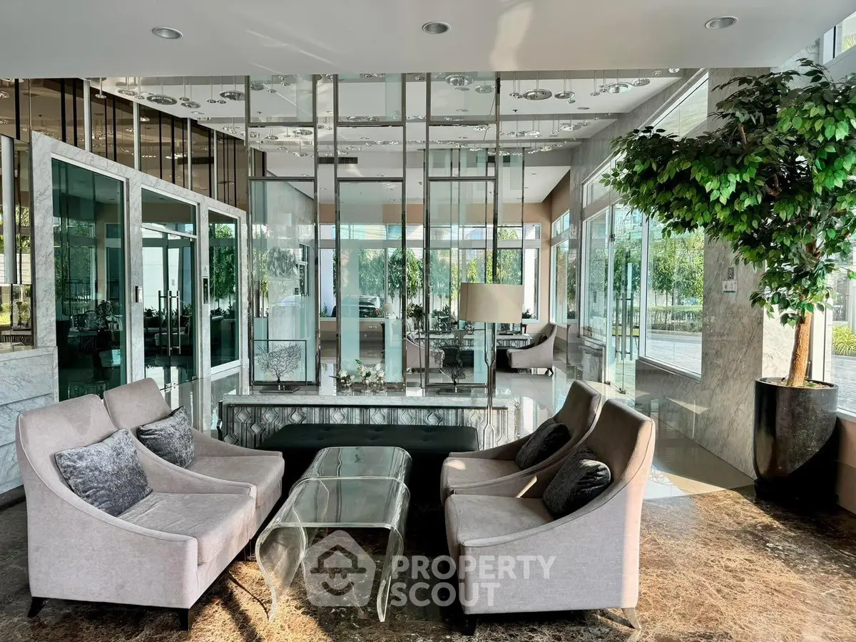 Luxurious modern living room with elegant furniture and glass walls offering a stunning view.