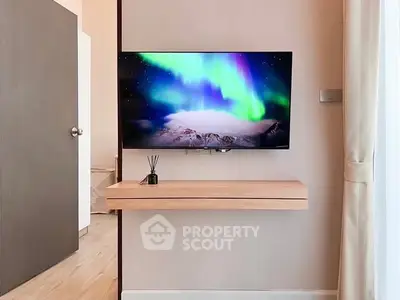 Modern living room with mounted TV and sleek wooden shelf