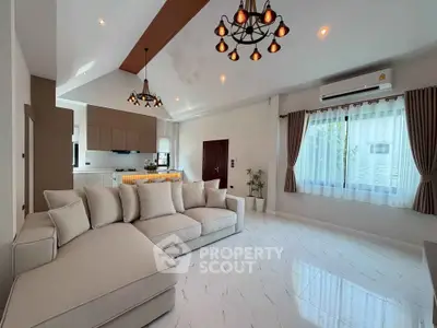 Spacious modern living room with elegant lighting and open kitchen layout