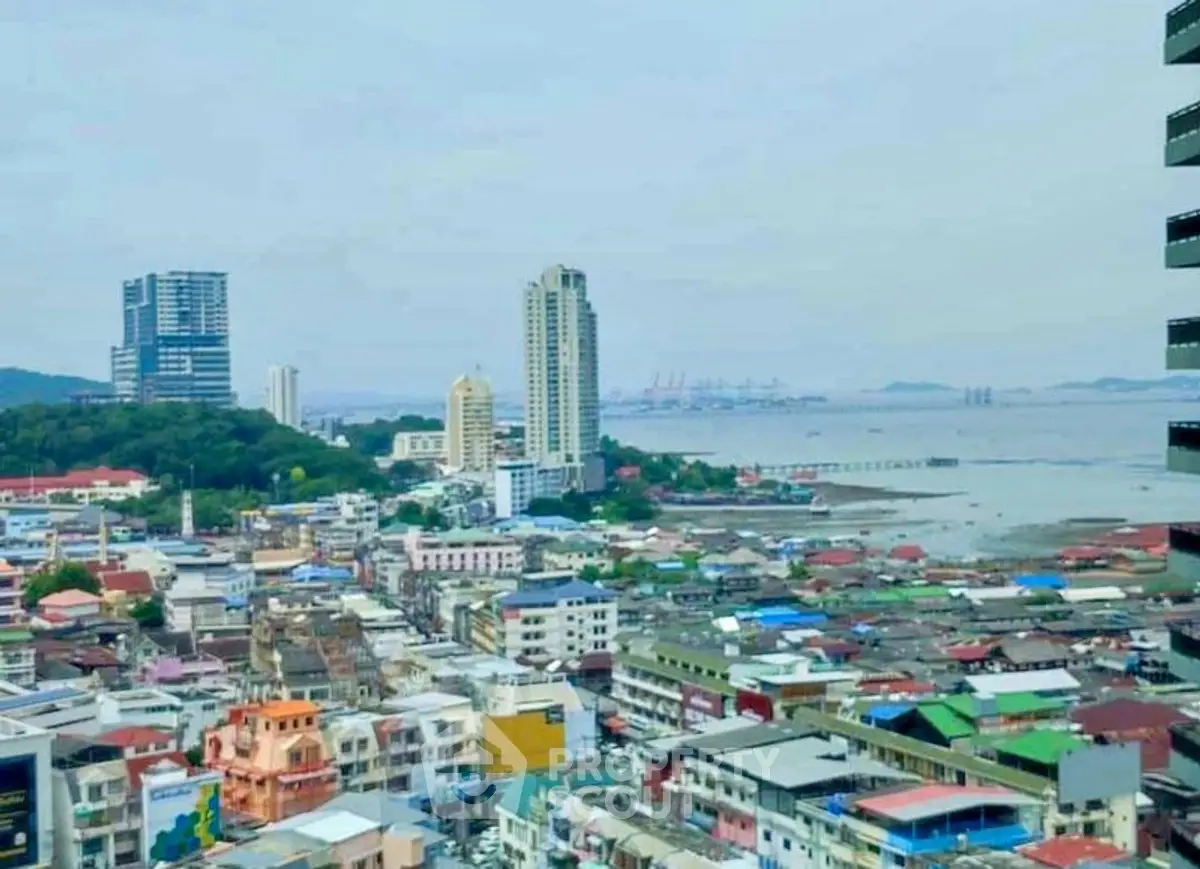 Stunning cityscape view with ocean backdrop and high-rise buildings.