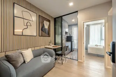 Modern living room with stylish decor and open kitchen layout in a cozy apartment.