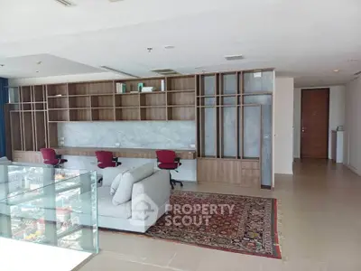 Spacious modern living room with built-in shelving and city view, perfect for urban living.
