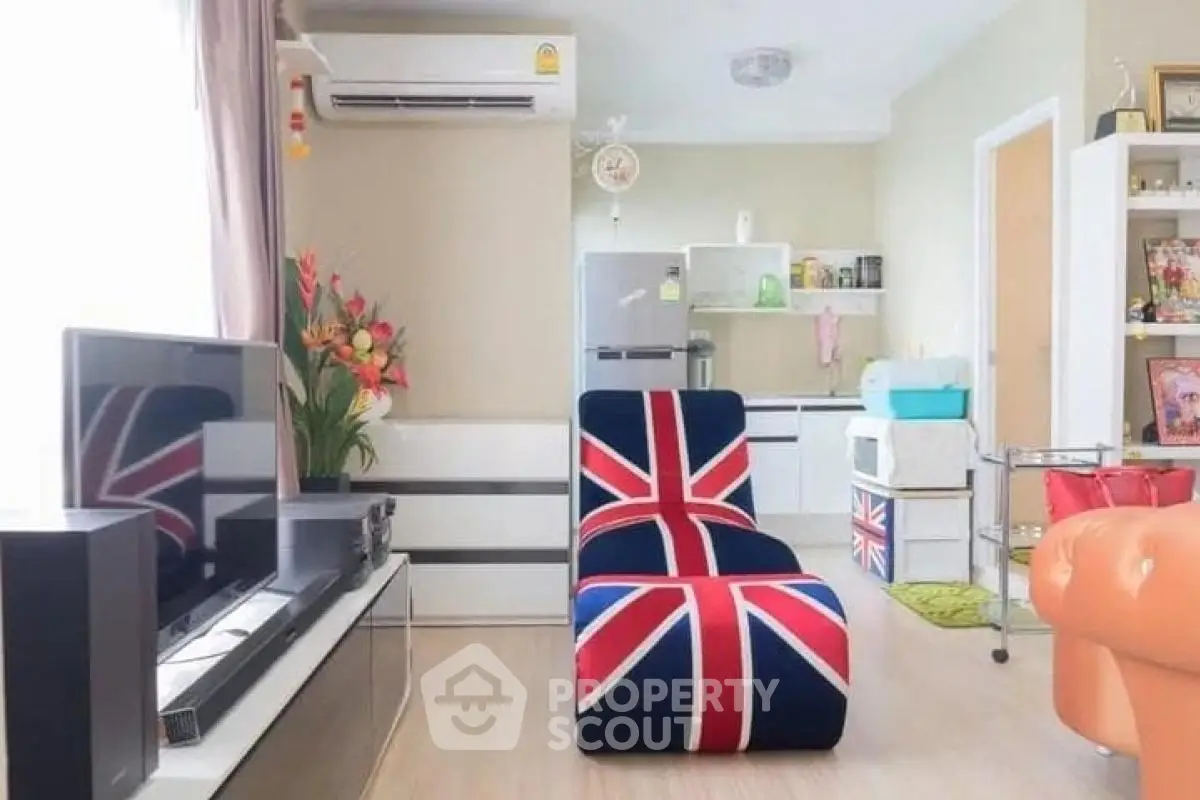 Stylish living room with modern decor and Union Jack themed furniture, featuring a cozy open layout and sleek appliances.